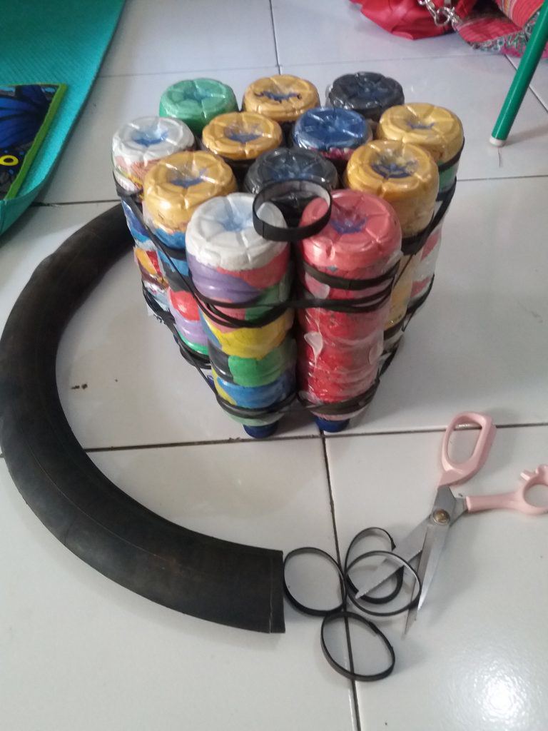 A module being made by cutting up a motorcycle tire inner tube | Indonesia